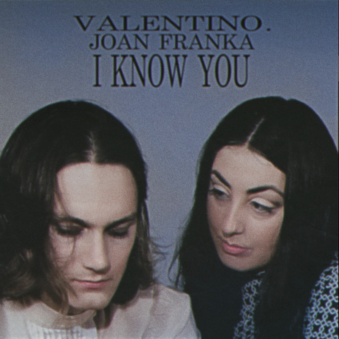 Vintage-style portrait of two people looking downward against a muted blue background.